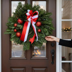 Christmas wreath arrangement with baubles and bow
