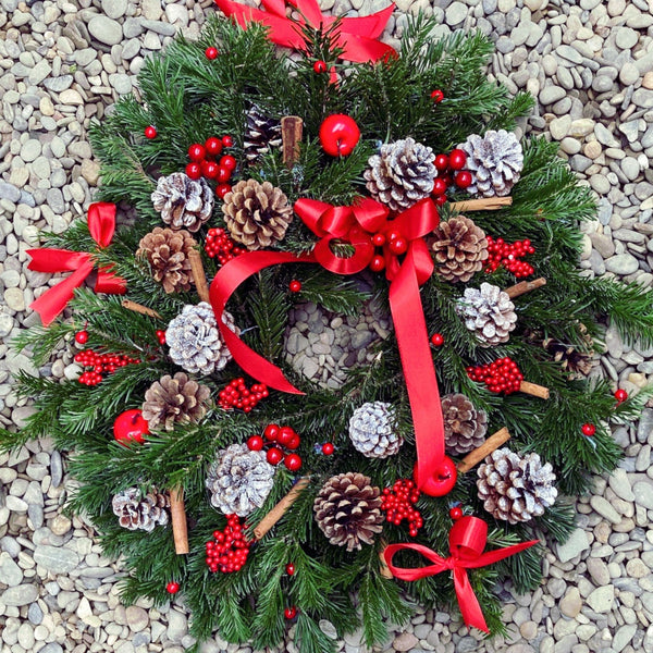 Christmas wreath made of natural fir, with cinnamon and cones