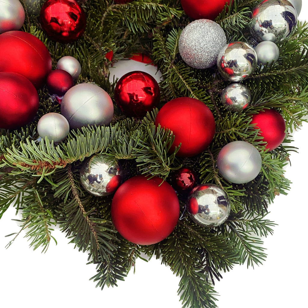 Natural fir wreath with red and silver baubles